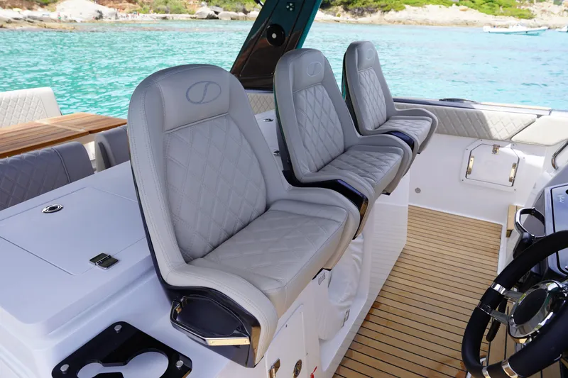  Yacht Photos Pics Luxury seating on 2025 Schaefer V44 yacht with elegant design and scenic ocean backdrop.