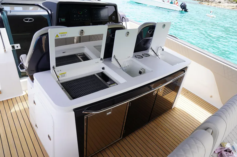  Yacht Photos Pics 2025 Schaefer V44 yacht interior with modern kitchen and seating, overlooking turquoise water.