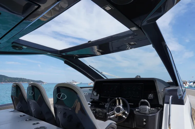  Yacht Photos Pics Interior view of 2025 Schaefer V44 yacht cockpit with modern controls and ocean backdrop.