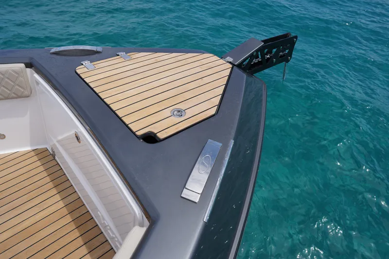  Yacht Photos Pics Schaefer V44 yacht deck, 2025 model, with teak finish on clear blue water.