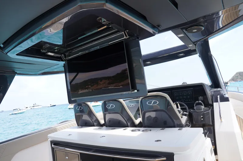  Yacht Photos Pics Interior of 2025 Schaefer V44 yacht with modern helm and retractable TV screen.