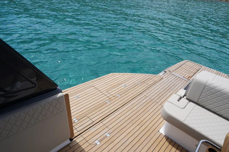  Yacht Photos Pics Luxury Schaefer V44 yacht deck with elegant seating, 2025 model, overlooking turquoise water.