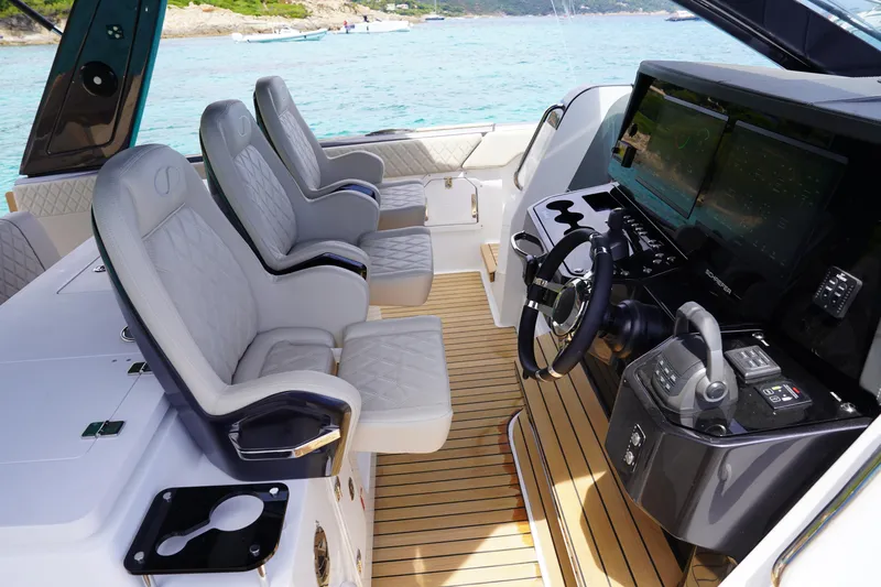  Yacht Photos Pics Luxury interior of 2025 Schaefer V44 yacht with modern helm and plush seating.