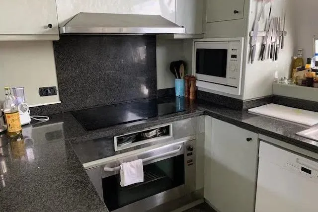  Yacht Photos Pics Modern kitchen on Mondomarine 30 yacht, featuring sleek appliances and granite countertops, 1995 model.