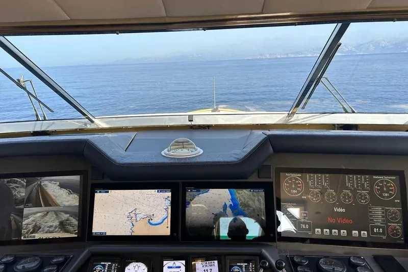  Yacht Photos Pics Cockpit view of 1995 Mondomarine 30 yacht with navigation screens and ocean horizon.
