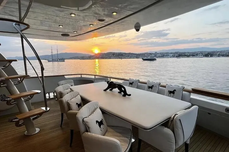  Yacht Photos Pics Luxurious Mondomarine 30 yacht deck with sunset view, elegant dining setup, 1995 model.