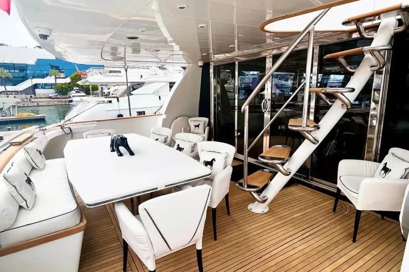  Yacht Photos Pics Luxurious 1995 Mondomarine 30 yacht deck with elegant seating and modern staircase.