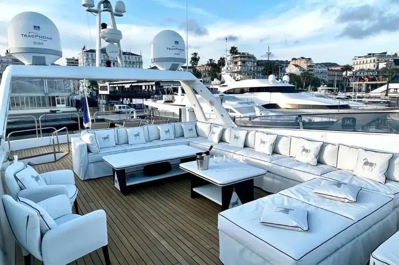  Yacht Photos Pics Luxurious Mondomarine 30 yacht deck with elegant seating, 1995 model, docked in a scenic marina.