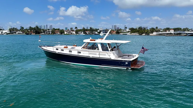Fiji Yacht Photos Pics 1999 Grand Banks 49 Eastbay HX yacht cruising on clear blue water.