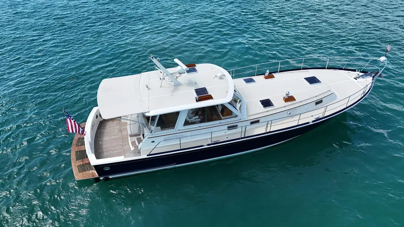 Fiji Yacht Photos Pics 1999 Grand Banks 49 Eastbay HX yacht cruising on clear blue water.