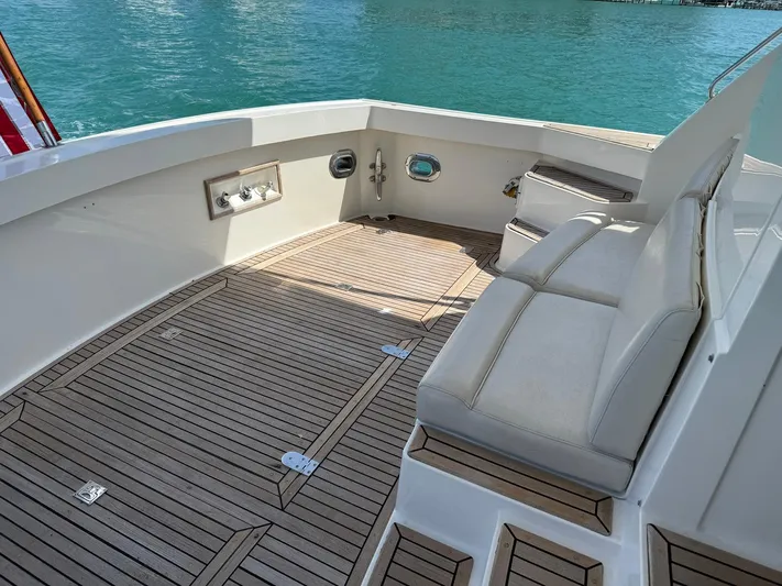 Fiji Yacht Photos Pics 1999 Grand Banks 49 Eastbay HX yacht deck with seating, overlooking turquoise water.