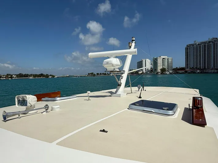 Fiji Yacht Photos Pics 1999 Grand Banks 49 Eastbay HX yacht deck with ocean and cityscape background.