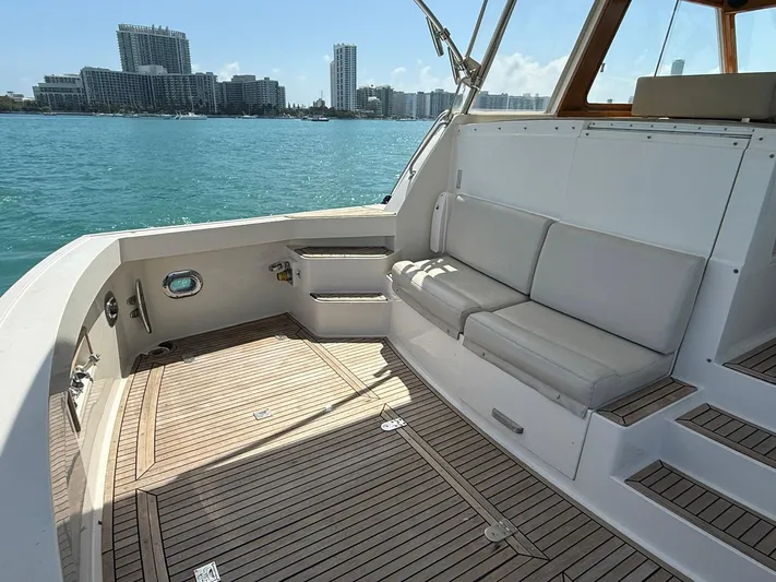 Fiji Yacht Photos Pics 1999 Grand Banks 49 Eastbay HX yacht with spacious deck and seating, overlooking city skyline.