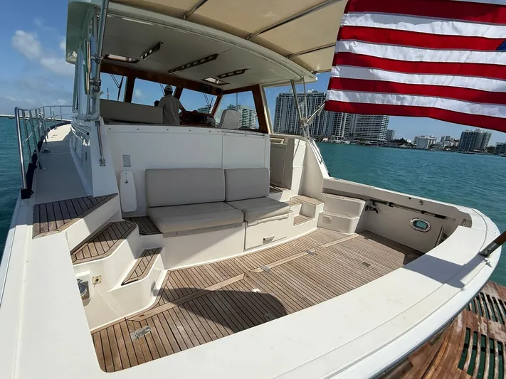 Fiji Yacht Photos Pics 1999 Grand Banks 49 Eastbay HX yacht with American flag, docked in a sunny marina.