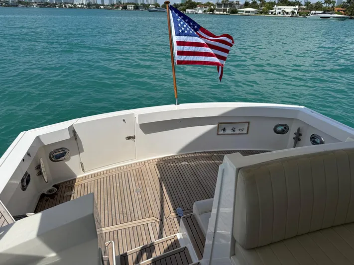 Fiji Yacht Photos Pics 1999 Grand Banks 49 Eastbay HX yacht deck with American flag, overlooking serene blue waters.