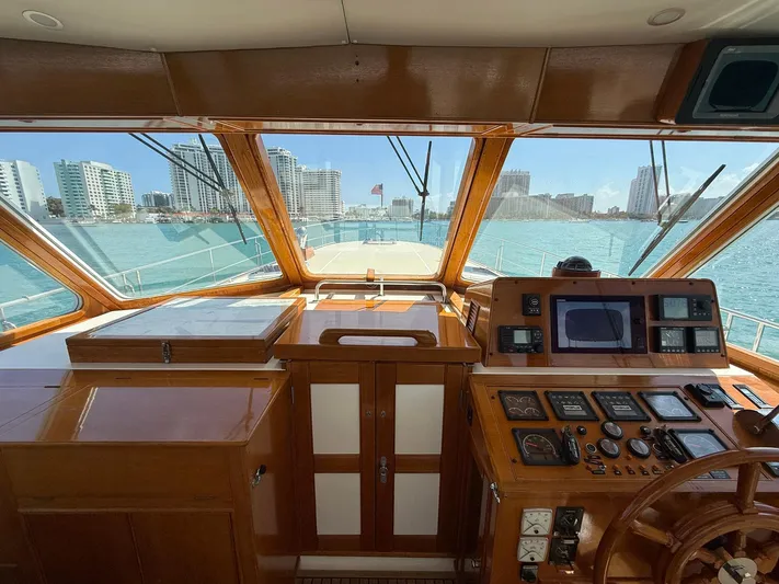 Fiji Yacht Photos Pics Interior view of 1999 Grand Banks 49 Eastbay HX yacht helm with city skyline.