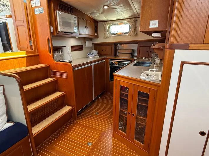 Fiji Yacht Photos Pics Interior of 1999 Grand Banks 49 Eastbay HX yacht with wooden cabinetry and modern kitchen amenities.