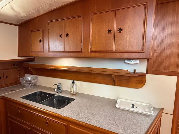 Fiji Yacht Photos Pics 1999 Grand Banks 49 Eastbay HX yacht kitchen with wooden cabinets and dual sink.