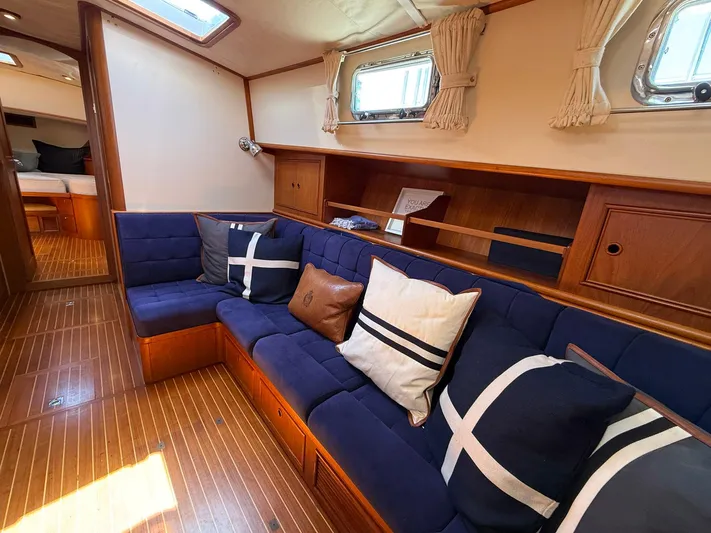 Fiji Yacht Photos Pics Interior of 1999 Grand Banks 49 Eastbay HX yacht with blue seating and decorative pillows.