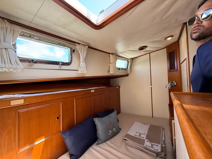 Fiji Yacht Photos Pics Cabin interior of 1999 Grand Banks 49 Eastbay HX with wooden furnishings and porthole windows.