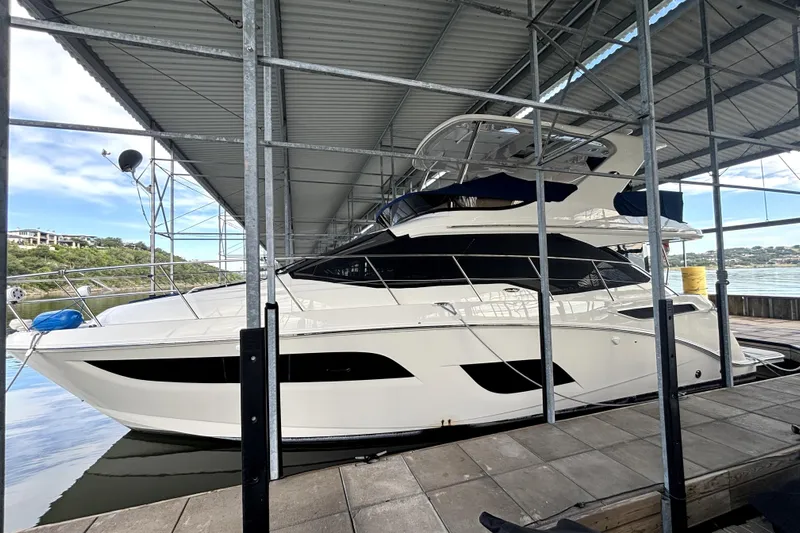 Smooth Yacht Photos Pics 2018 Sea Ray Fly 460 yacht docked under a covered marina.