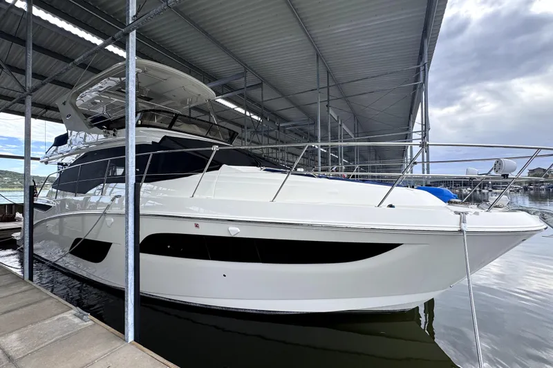 Smooth Yacht Photos Pics 2018 Sea Ray Fly 460 yacht docked under a covered marina.