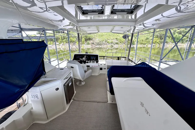 Smooth Yacht Photos Pics 2018 Sea Ray Fly 460 yacht interior with helm, seating, and scenic water view.