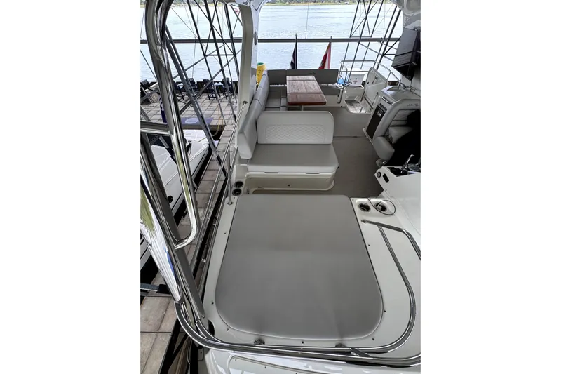 Smooth Yacht Photos Pics 2018 Sea Ray Fly 460 yacht interior with seating and table, docked by the water.