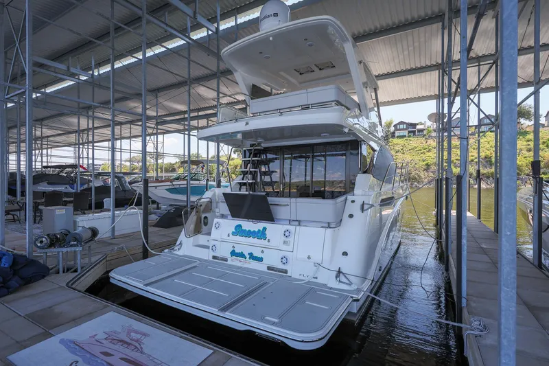 Smooth Yacht Photos Pics 2018 Sea Ray Fly 460 yacht docked in a covered marina.