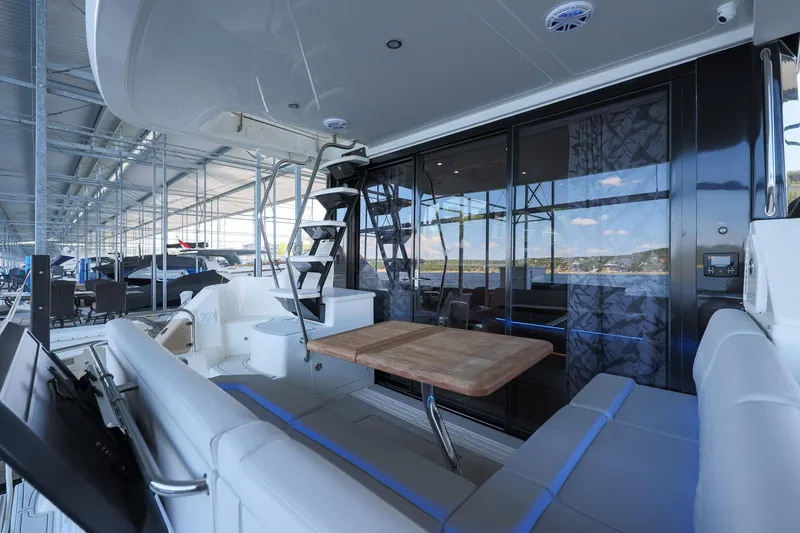 Smooth Yacht Photos Pics Luxurious 2018 Sea Ray Fly 460 yacht interior with seating and table, docked in a marina.