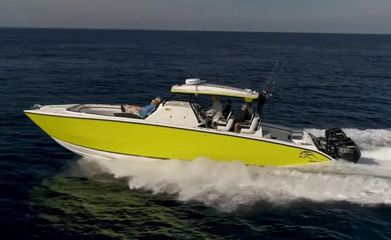Big Sexy Yacht Photos Pics 2020 Prowler 42 boat cruising on open water, vibrant yellow hull, multiple passengers onboard.