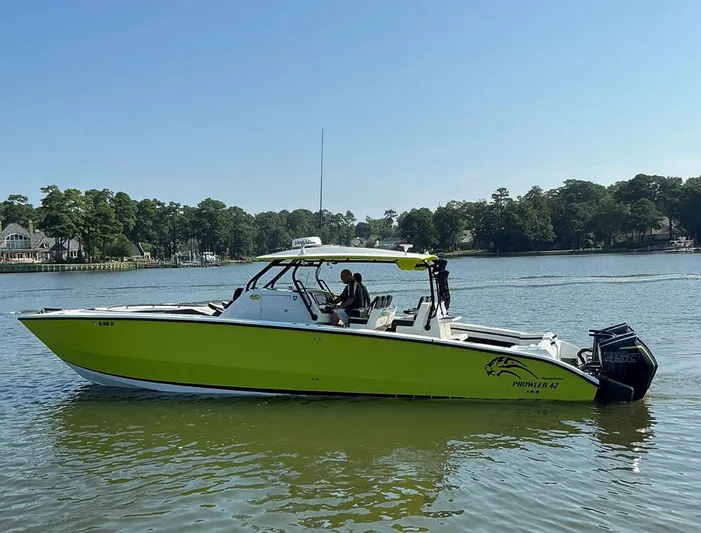 Big Sexy Yacht Photos Pics 2020 Prowler 42 boat with vibrant green hull cruising on a calm lake.