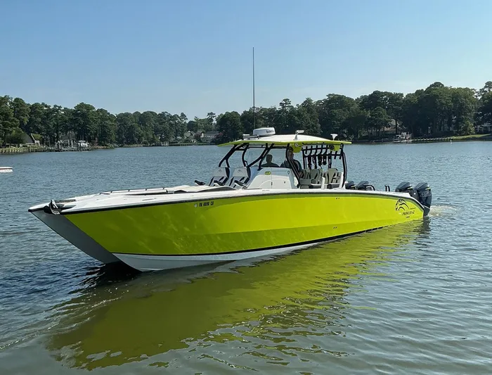 Big Sexy Yacht Photos Pics 2020 Prowler 42 boat in vibrant yellow on a calm lake.