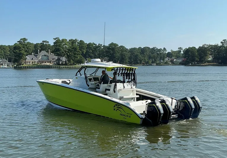Big Sexy Yacht Photos Pics 2020 Prowler 42 boat with multiple engines cruising on a serene lake.