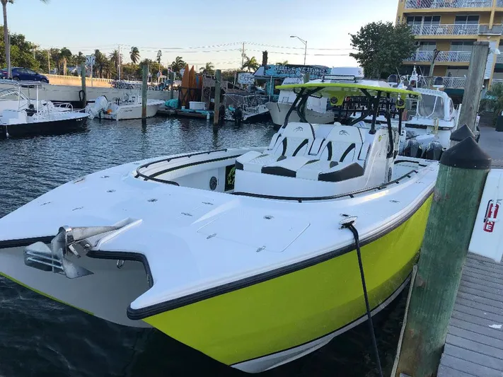 Big Sexy Yacht Photos Pics 2020 Prowler 42 boat docked, featuring a sleek white and lime green design.