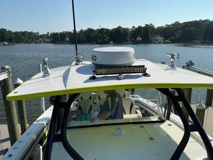 Big Sexy Yacht Photos Pics 2020 Prowler 42 boat docked by a scenic waterfront with lush greenery.