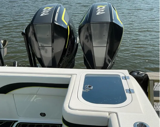 Big Sexy Yacht Photos Pics Twin outboard motors on a 2020 Prowler 42 boat, docked on calm water.