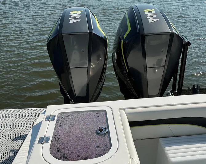 Big Sexy Yacht Photos Pics Twin outboard motors on a 2020 Prowler 42 boat, docked on calm water.