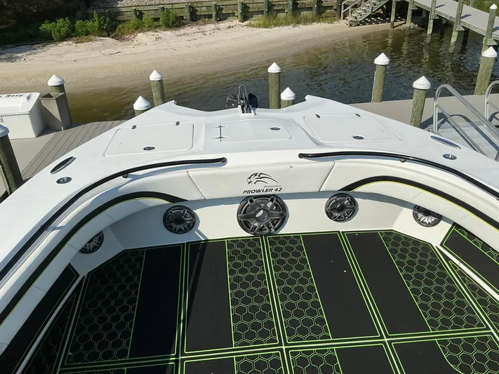 Big Sexy Yacht Photos Pics 2020 Prowler 42 boat docked by a sandy shore, featuring stylish deck design.