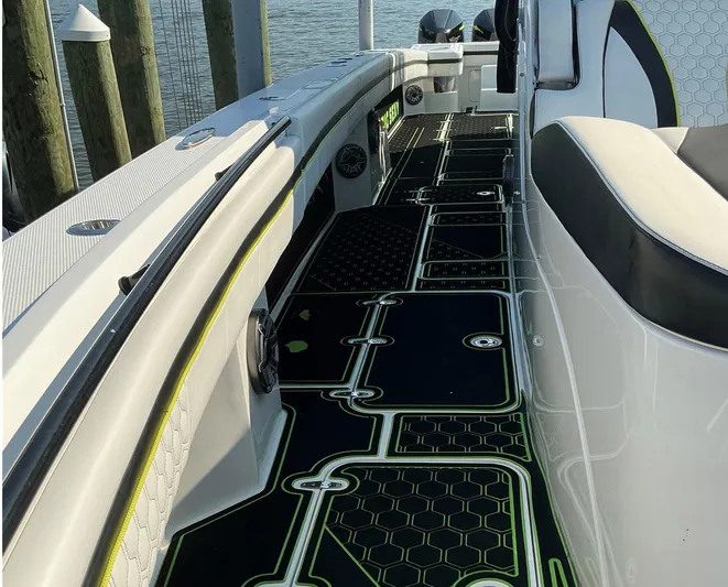 Big Sexy Yacht Photos Pics 2020 Prowler 42 boat interior with stylish black and green flooring, docked by the water.
