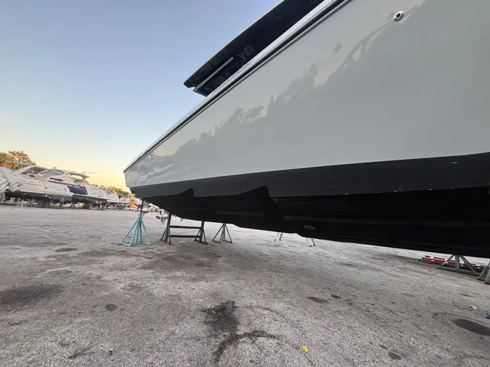  Yacht Photos Pics 2022 Fountain 38 SC boat on stands, side view, outdoor storage area.