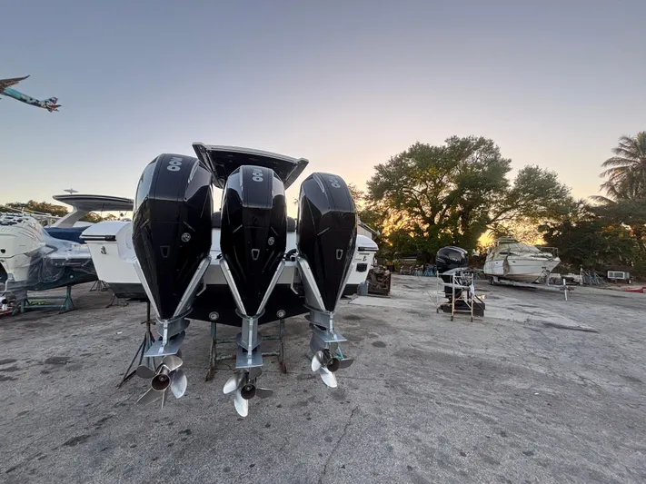 Yacht Photos Pics 2022 Fountain 38 SC boat with triple outboard engines at sunset.