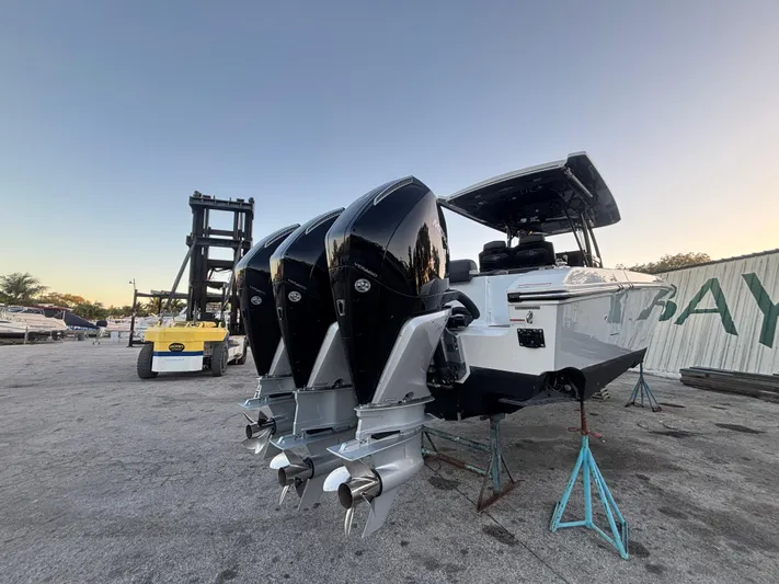 Yacht Photos Pics 2022 Fountain 38 SC boat with triple outboard engines on a dock.