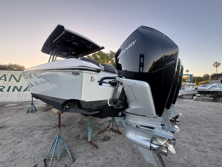  Yacht Photos Pics 2022 Fountain 38 SC boat with Mercury outboard engines on stands, outdoor setting.