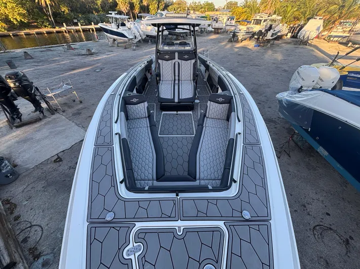  Yacht Photos Pics 2022 Fountain 38 SC boat with sleek design and spacious seating at a marina.