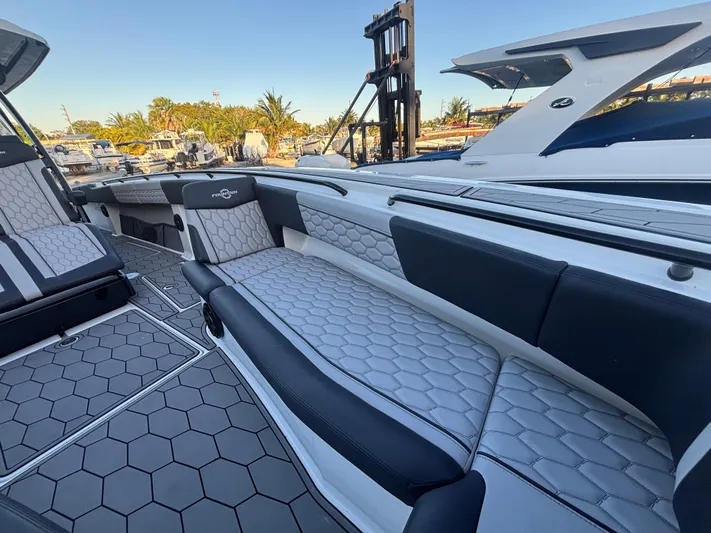  Yacht Photos Pics 2022 Fountain 38 SC boat interior with hexagonal-patterned seating and sleek design.