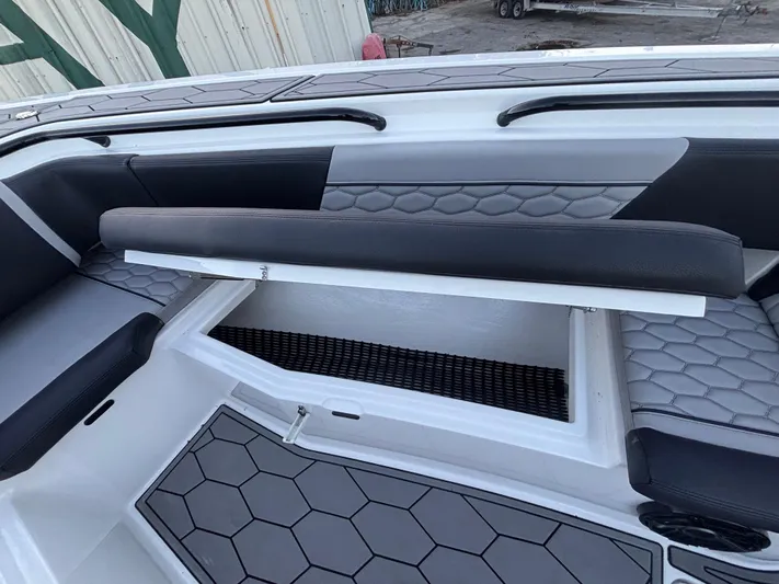  Yacht Photos Pics 2022 Fountain 38 SC boat interior with hexagonal pattern seating and storage compartment.