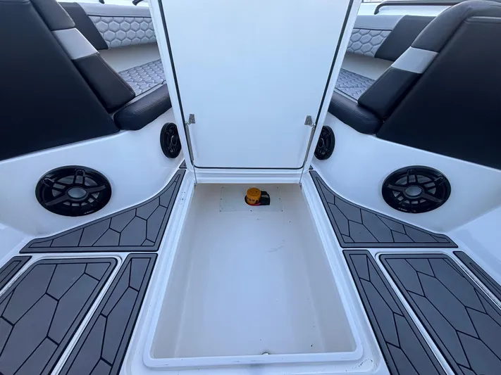  Yacht Photos Pics 2022 Fountain 38 SC boat interior with seating, speakers, and storage compartment.