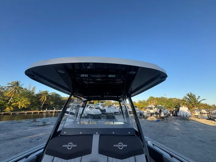  Yacht Photos Pics 2022 Fountain 38 SC boat docked under clear blue sky.