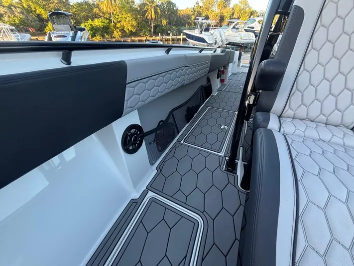 Yacht Photos Pics 2022 Fountain 38 SC boat interior with hexagonal-patterned seating and flooring.